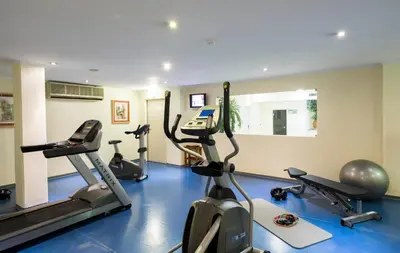 a gym with several treadmills and exercise bikes at Vila Gale Marina in Vilamoura
