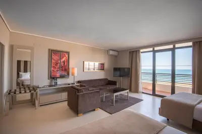 a living room with a couch and a room with a view at Vila Gale Ampalius in Vilamoura