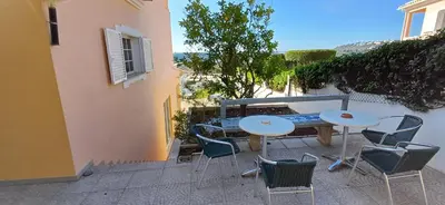a patio with two tables and chairs on a balcony at Villa Ramos in Albufeira