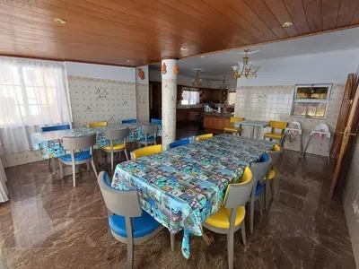 a dining room with a long table and chairs at Villa Ramos in Albufeira