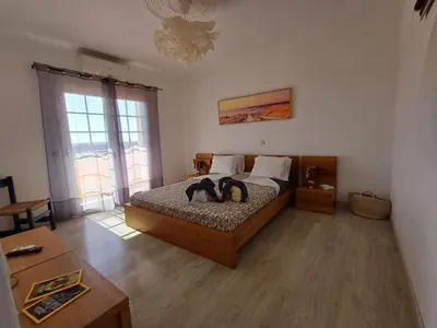 a bedroom with a bed with two penguins on it at Villa Ramos in Albufeira