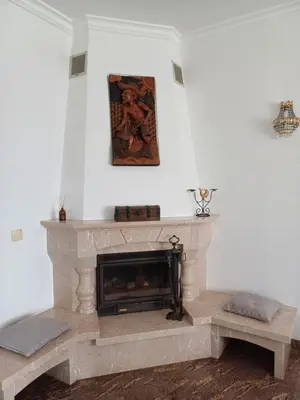 a living room with a fireplace and a painting on the wall at Villa Ramos in Albufeira