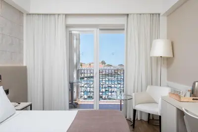 a hotel room with a bed and a window with a view at AP Eva Senses in Faro