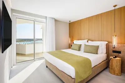 a bathroom with two sinks and a large mirror at AP Eva Senses in Faro