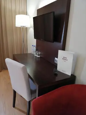 a hotel room with a bed and a picture on the wall at Hotel Monaco in Faro