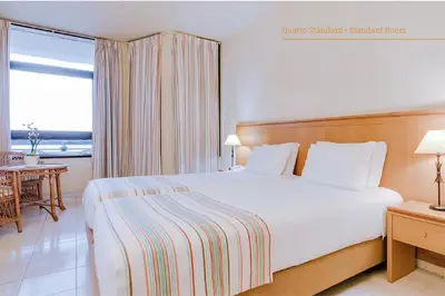 a bedroom with a large white bed and a window at Auramar Beach Resort in Albufeira