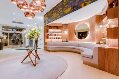 a living room with a couch and a table at Hotel Sol e Mar Albufeira - Adults Only in Albufeira