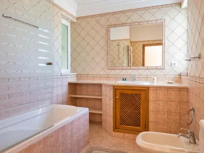 a bathroom with a tub sink and a mirror at Villa Villa Natura by Interhome in Guia