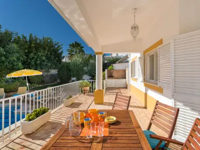 a patio with a wooden table with glasses on it at Villa Villa Natura by Interhome in Guia