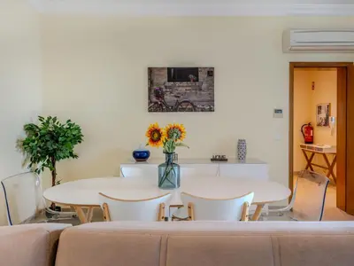 a dining room with two tables and chairs and flowers at Villa Colibri by Interhome in Patroves
