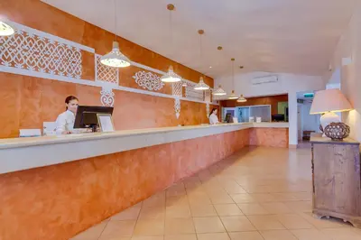 a woman sitting at a counter in a restaurant at Monica Isabel Beach Club in Albufeira