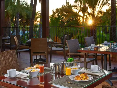 a table with food and drinks on a patio at Ria Park Hotel & Spa in Vale do Lobo