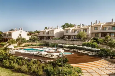 a bedroom with a large white bed and a balcony at Grande Real Santa Eulalia Resort & Hotel Spa in Albufeira