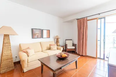a living room with a couch and a table at Hotel da Aldeia - Adults Only in Albufeira