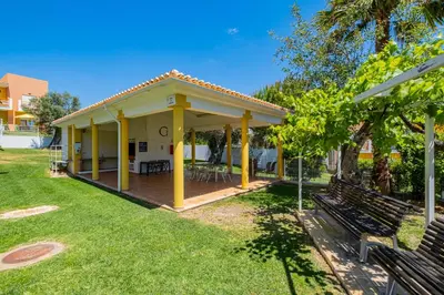 a house with a covered porch with a bench at Pool&Beach in Encosta de São José in Albufeira