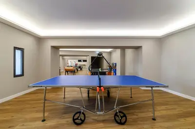 a blue ping pong table in a living room at Jupiter Albufeira Hotel - Family & Fun - All Inclusive in Albufeira