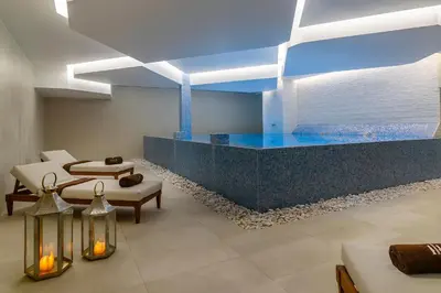 a room with a swimming pool in the middle at Jupiter Albufeira Hotel - Family & Fun - All Inclusive in Albufeira