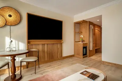 a living room with a large flat screen tv at Hyatt Regency Vilamoura Algarve in Vilamoura