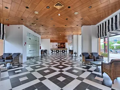a lobby with chairs and a wooden ceiling at Dom Pedro Portobelo in Vilamoura