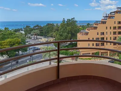 a balcony with a view of the ocean at Dom Pedro Portobelo in Vilamoura