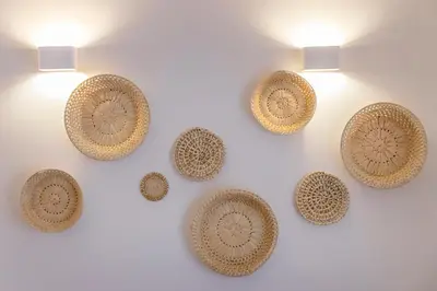 a group of brown plates on a wall with lights at Clube Maria Luisa in Albufeira