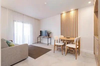 a living room with a couch and a table at Clube Maria Luisa in Albufeira