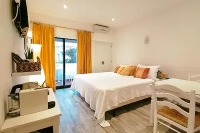 a bedroom with a white bed and a window at Cosy and Sweet Apartment in Albufeira in Albufeira