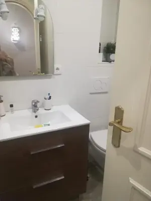 a bathroom with a sink and a toilet and a mirror at Cosy and Sweet Apartment in Albufeira in Albufeira