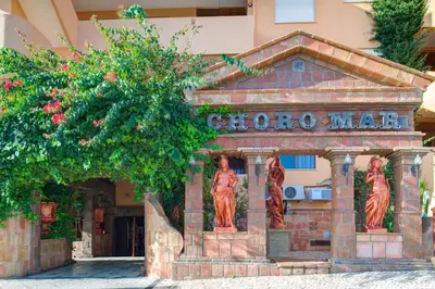 a building with statues in front of it at Choromar Apartments in Albufeira