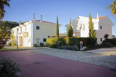 a white building with a parking meter in front of it at Cegonha Country Club in Vilamoura