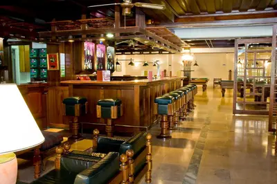 a bar with a row of chairs in a room at Hotel Balaia Mar in Albufeira