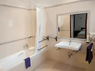 a bathroom with a sink and a mirror at Hotel Balaia Mar in Albufeira