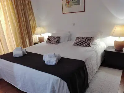 a bedroom with two beds with towels on them at Apartamentos da Balaia in Albufeira