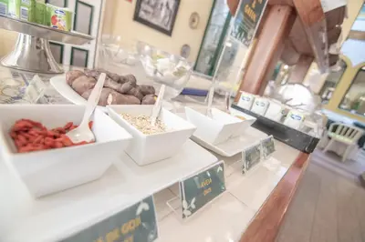 a counter with several bowls of food on a table at Loule Jardim Hotel in Loulé