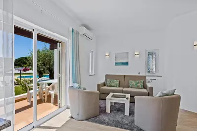 a living room with a couch and a table at Prado Villas in Vilamoura