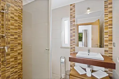 a bathroom with a sink and a shower at Prado Villas in Vilamoura