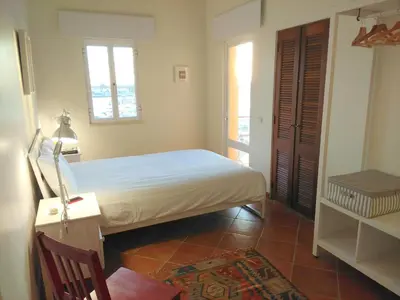 a bedroom with a bed and a desk and window at TP Aqua Marina, Vilamoura Triplex Apartment in Quarteira