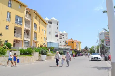 a group of people walking down a street at TP Aqua Marina, Vilamoura Triplex Apartment in Quarteira