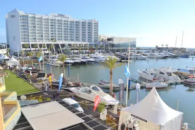 a marina with boats in the water and a building at TP Aqua Marina, Vilamoura Triplex Apartment in Quarteira
