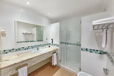 a bathroom with a sink and a shower at Hotel Apartamento Brisa Sol in Albufeira