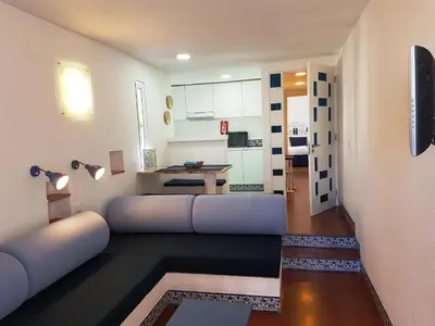 a living room with a couch and a table at Apartamentos Turisticos Soldoiro in Albufeira