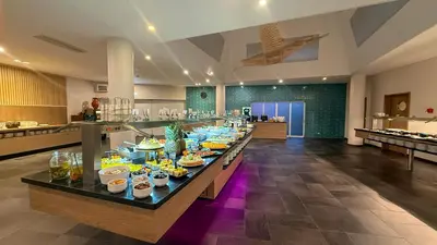 a cafeteria with a counter with fruit on it at AP Adriana Beach Resort in Albufeira