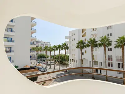 a view from a window of a building with palm trees at Hotel Atismar in Quarteira