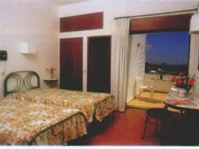 a hotel room with a bed and a balcony at Torre Velha AL in Albufeira