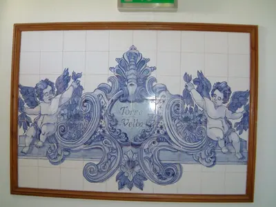 a tile wall with a picture of two angels at Torre Velha AL in Albufeira