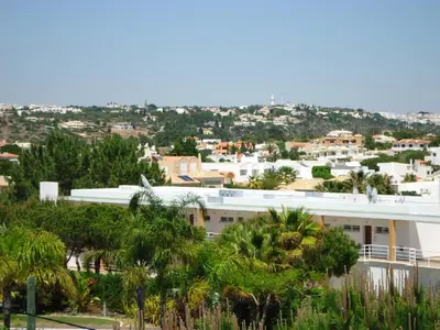 a view of a city with palm trees and buildings at Torre Velha AL in Albufeira