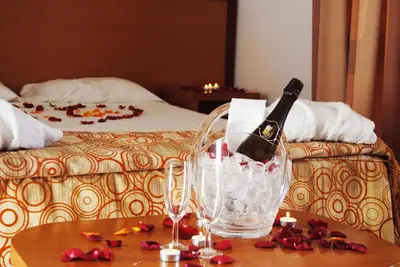 a bottle of champagne and a glass on a table at Hotel Pinhal do Sol in Quarteira