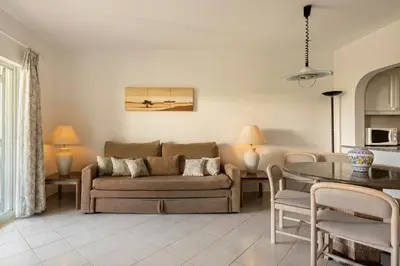 a living room with a couch and a table at Balaia Golf Village in Albufeira