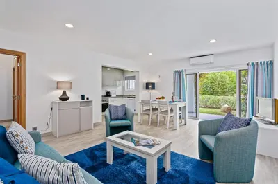 a living room with a couch and chairs and a table at Vale San Antonio Apartments in Almancil
