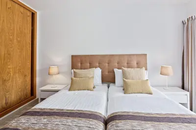 a bedroom with two beds and two lamps on tables at Vale San Antonio Apartments in Almancil